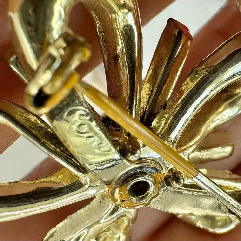 Coro vintage gold tone and blue rhinestone bow brooch